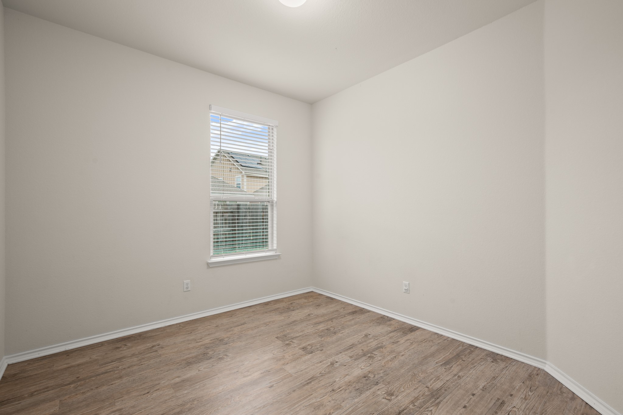 380 Bonnet Boulevard Georgetown, TX 78628 - Photo 23 of 26 a view of an empty room with wooden floor and a window