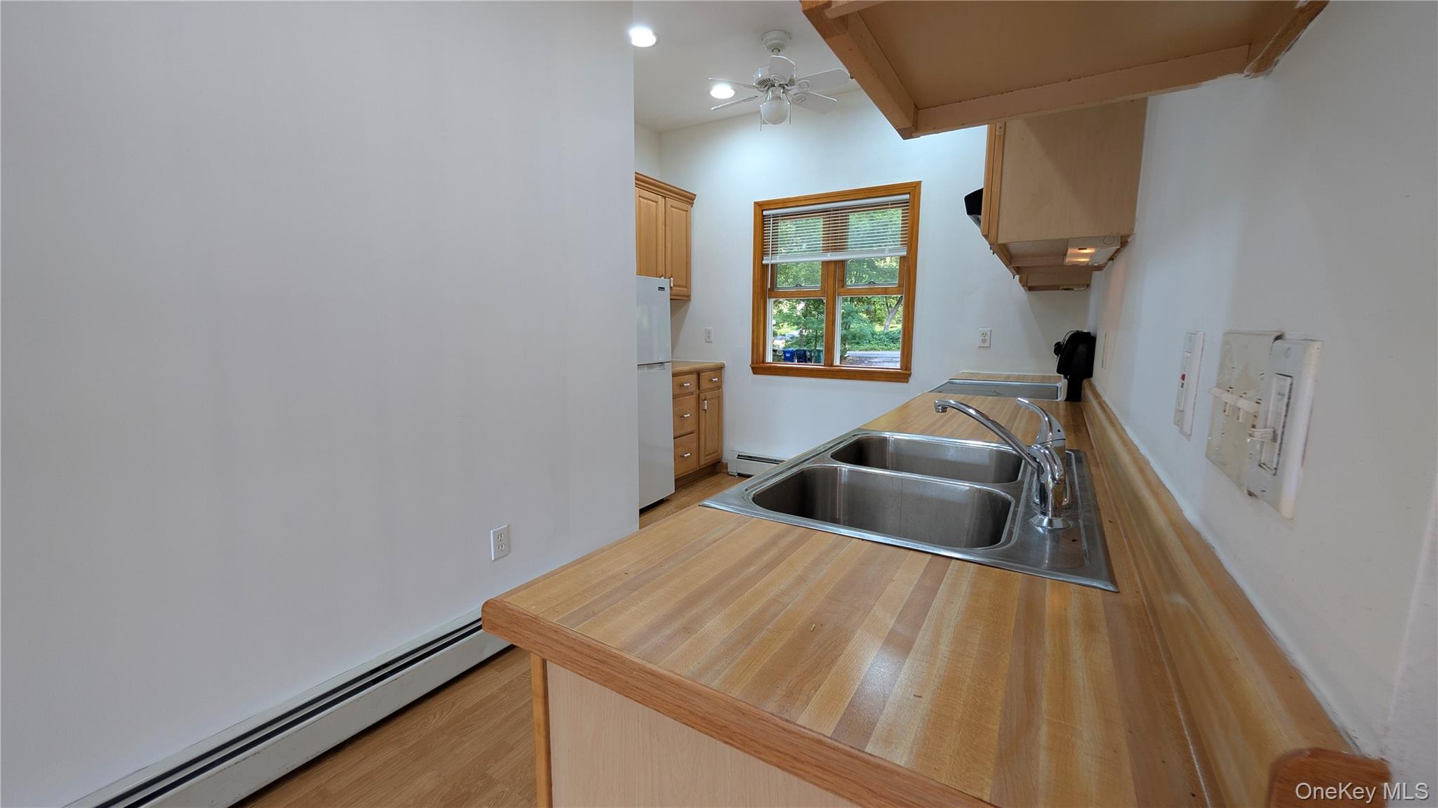 169 Shear Hill Road Mahopac, NY 10541 - Photo 15 of 31 Kitchen with a baseboard radiator, light countertops, light wood-type flooring, freestanding refrigerator, and stove