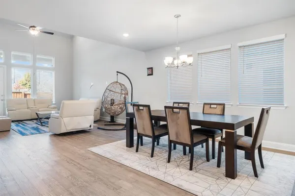a view of a dining room with furniture and chandelier