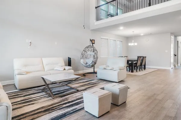 a living room with furniture a table and chairs