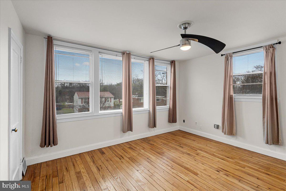 4027 D Street Southeast Washington, DC 20019 - Photo 14 of 32 a view of empty room with wooden floor and fan
