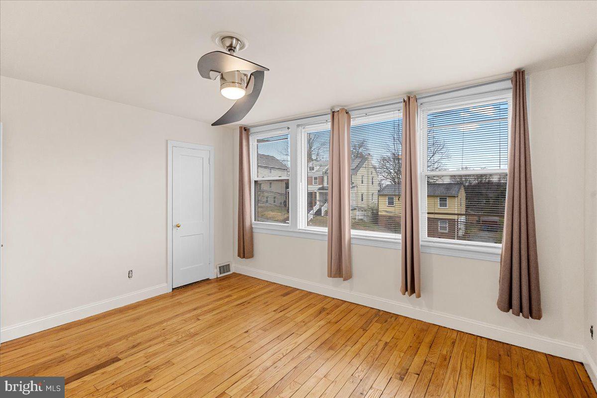 4027 D Street Southeast Washington, DC 20019 - Photo 15 of 32 a view of empty room with wooden floor and fan