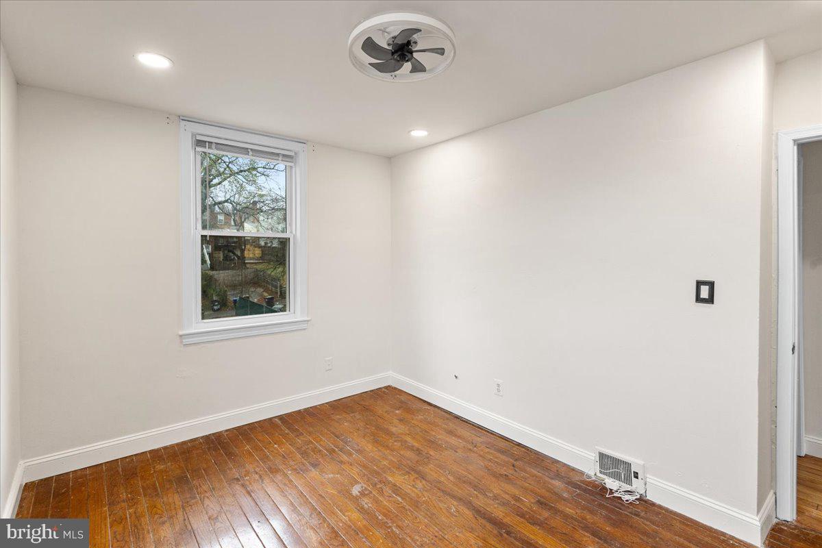 4027 D Street Southeast Washington, DC 20019 - Photo 17 of 32 an empty room with wooden floor and windows