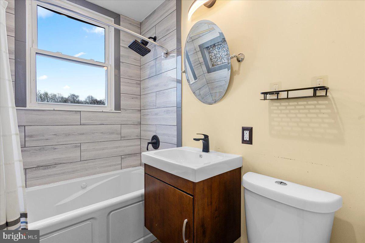 4027 D Street Southeast Washington, DC 20019 - Photo 19 of 32 a bathroom with a sink a toilet and a bathtub