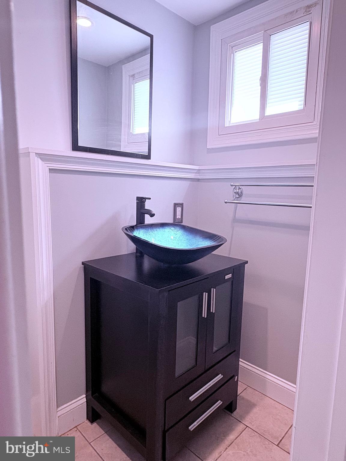4027 D Street Southeast Washington, DC 20019 - Photo 30 of 32 a bathroom with a sink a mirror and a toilet