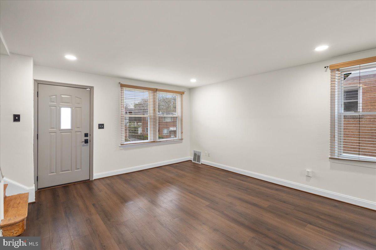 4027 D Street Southeast Washington, DC 20019 - Photo 4 of 32 a view of an empty room with wooden floor and windows