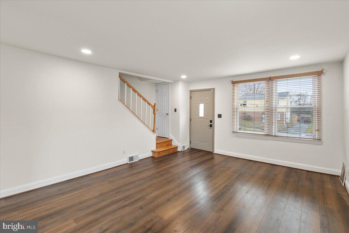 4027 D Street Southeast Washington, DC 20019 - Photo 5 of 32 a view of an empty room with wooden floor and a window