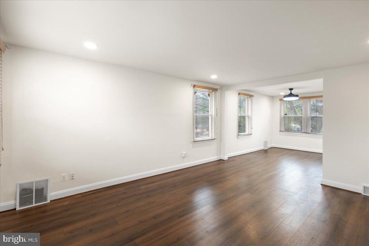 4027 D Street Southeast Washington, DC 20019 - Photo 7 of 32 an empty room with wooden floor and windows