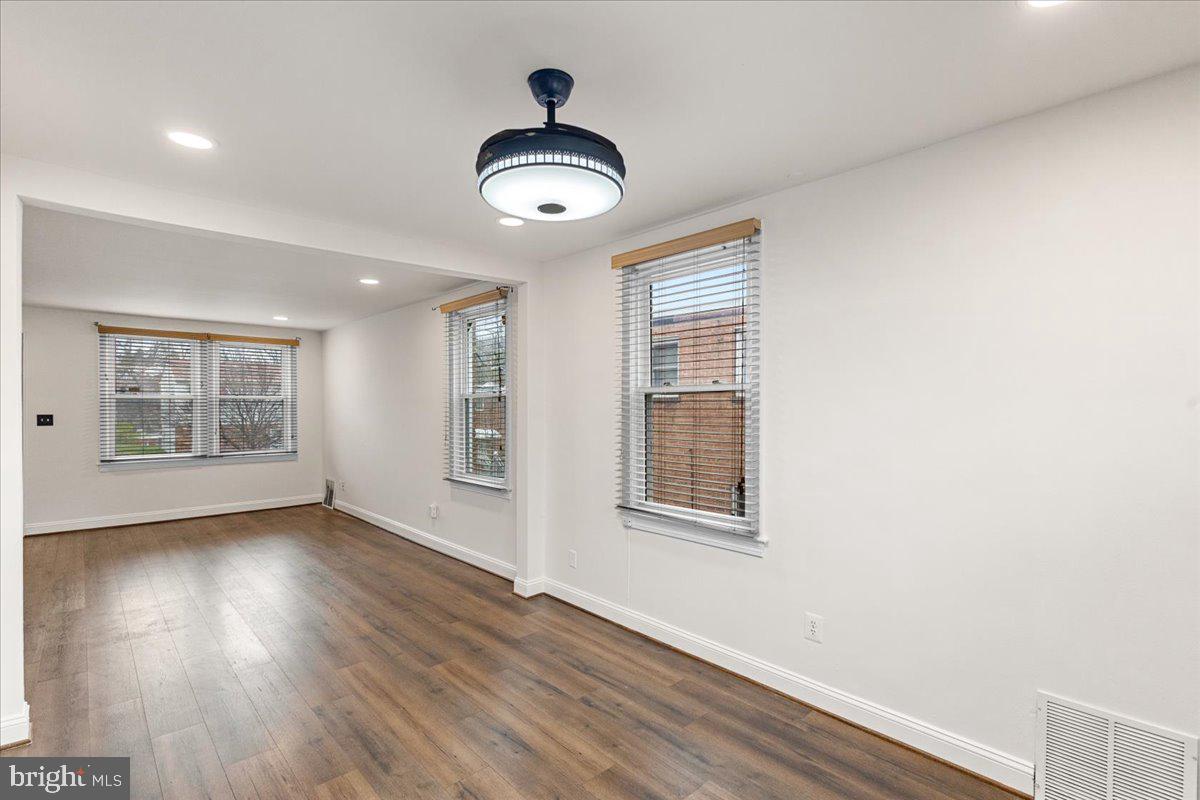 4027 D Street Southeast Washington, DC 20019 - Photo 9 of 32 an empty room with wooden floor and windows