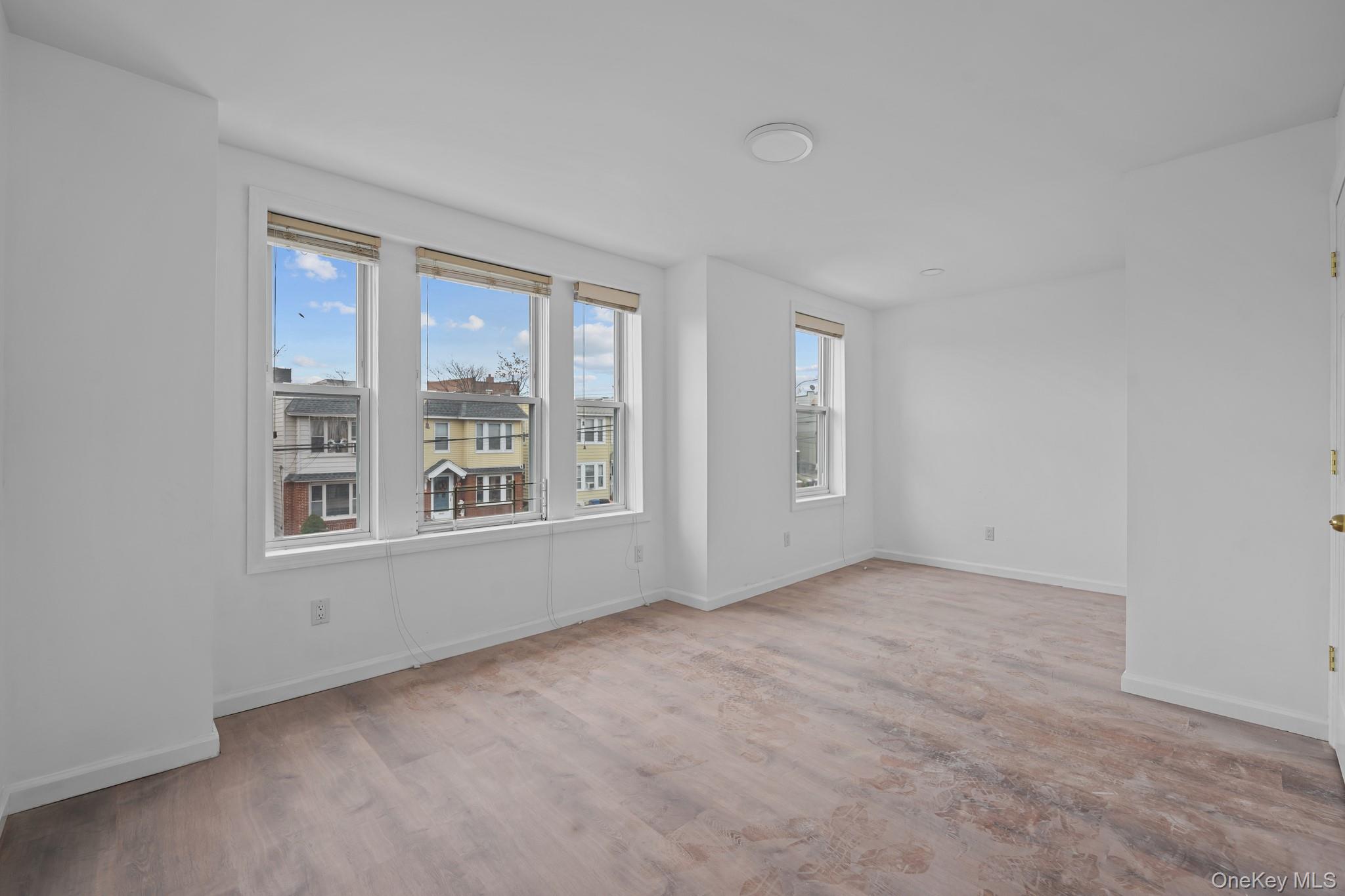 58-44 Fresh Pond Road Queens, NY 11378 - Photo 14 of 25 an empty room with windows