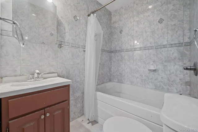 a bathroom with a sink vanity granite toilet tub and shower