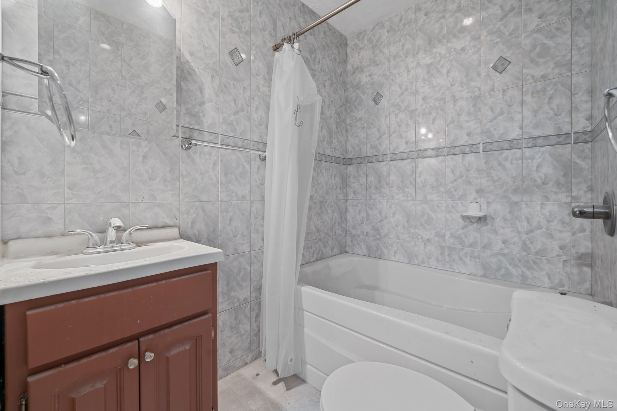 58-44 Fresh Pond Road Queens, NY 11378 - Photo 15 of 30 a bathroom with a sink vanity granite toilet tub and shower