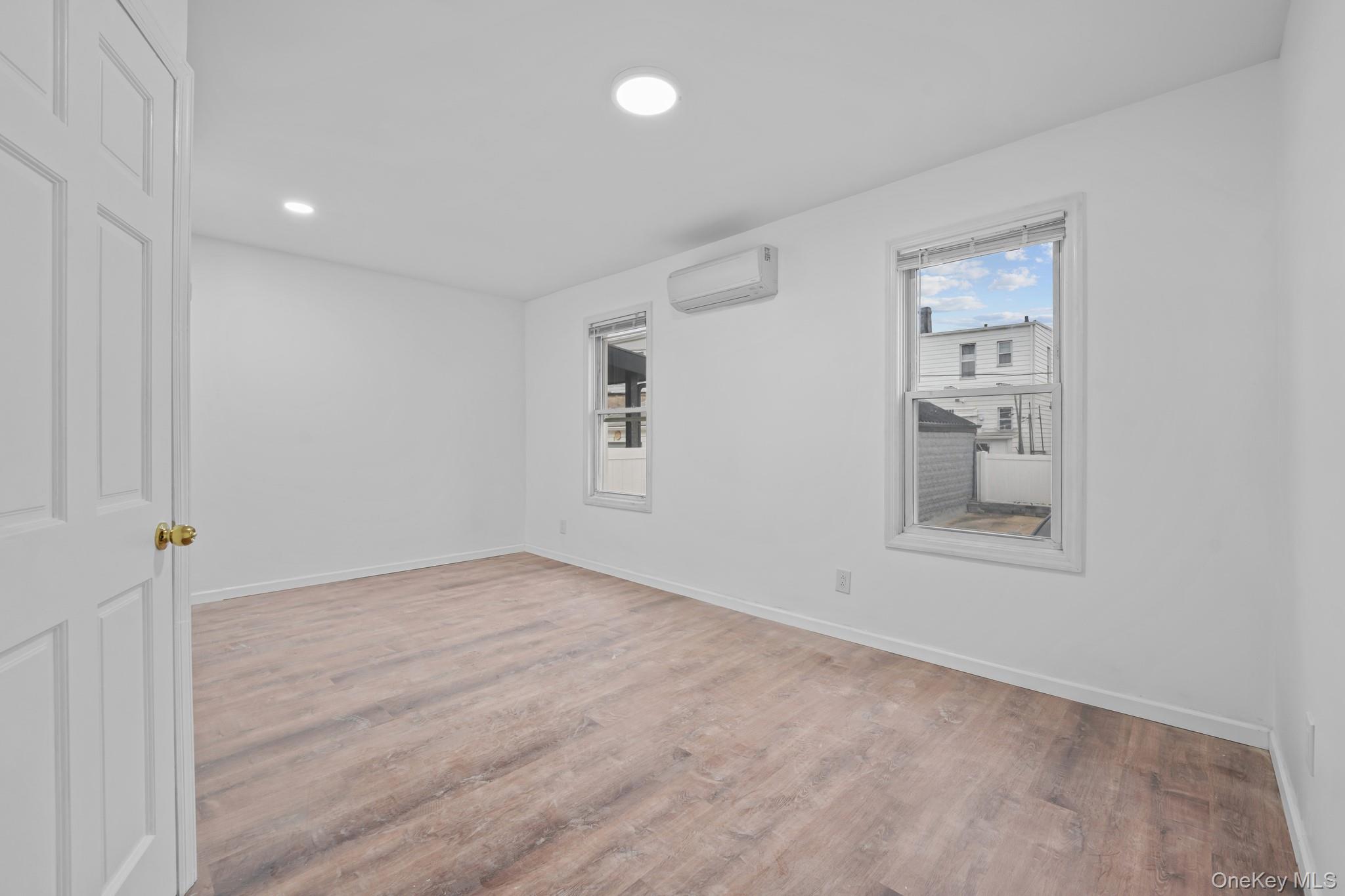 58-44 Fresh Pond Road Queens, NY 11378 - Photo 17 of 30 wooden floor in an empty room with a window