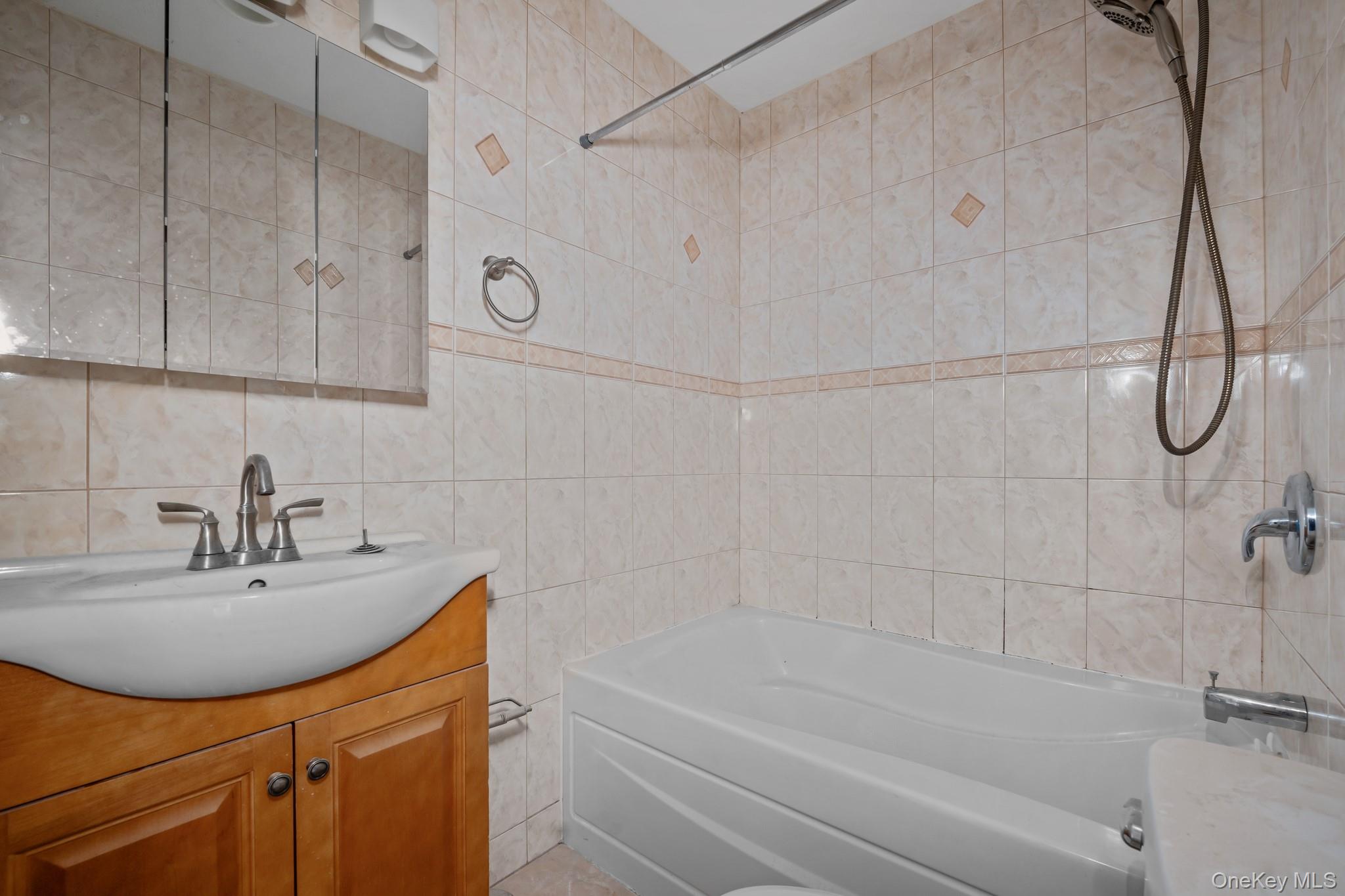 58-44 Fresh Pond Road Queens, NY 11378 - Photo 21 of 30 a bathroom with a sink and a bathtub