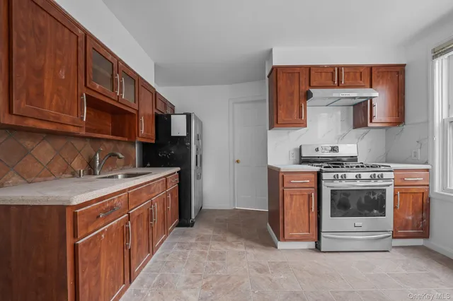 a kitchen with stainless steel appliances granite countertop a stove and a sink