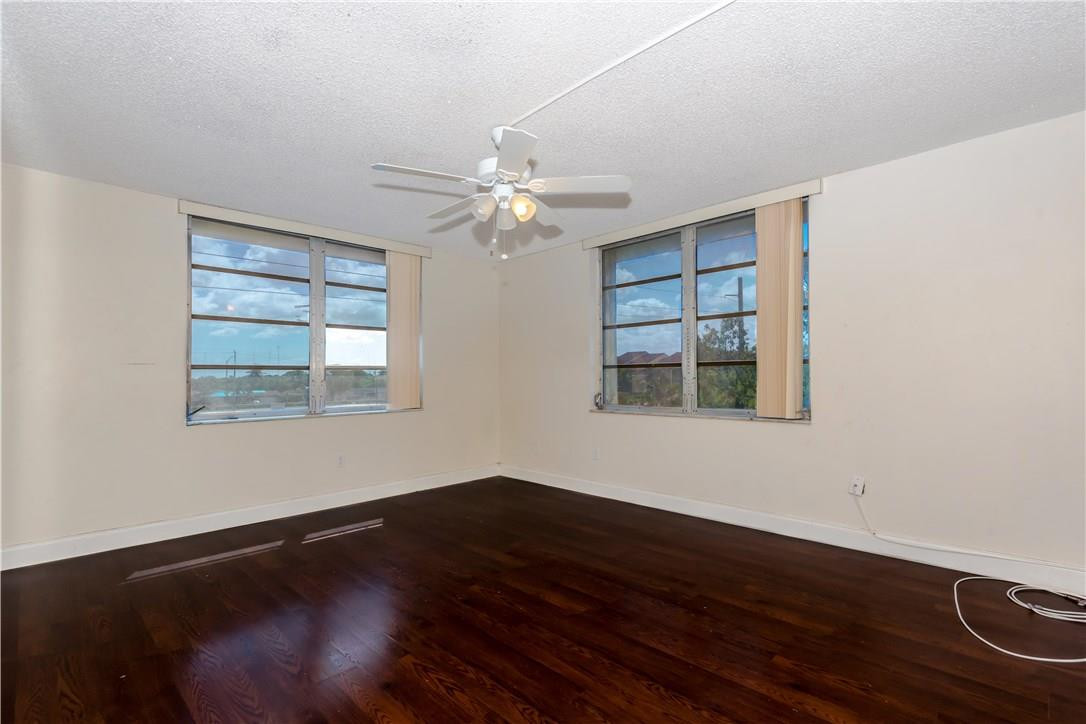 3285 Foxcroft Road, Unit E317 Miramar, FL 33025 - Photo 13 of 28 a view of wooden floor in an empty room with a window