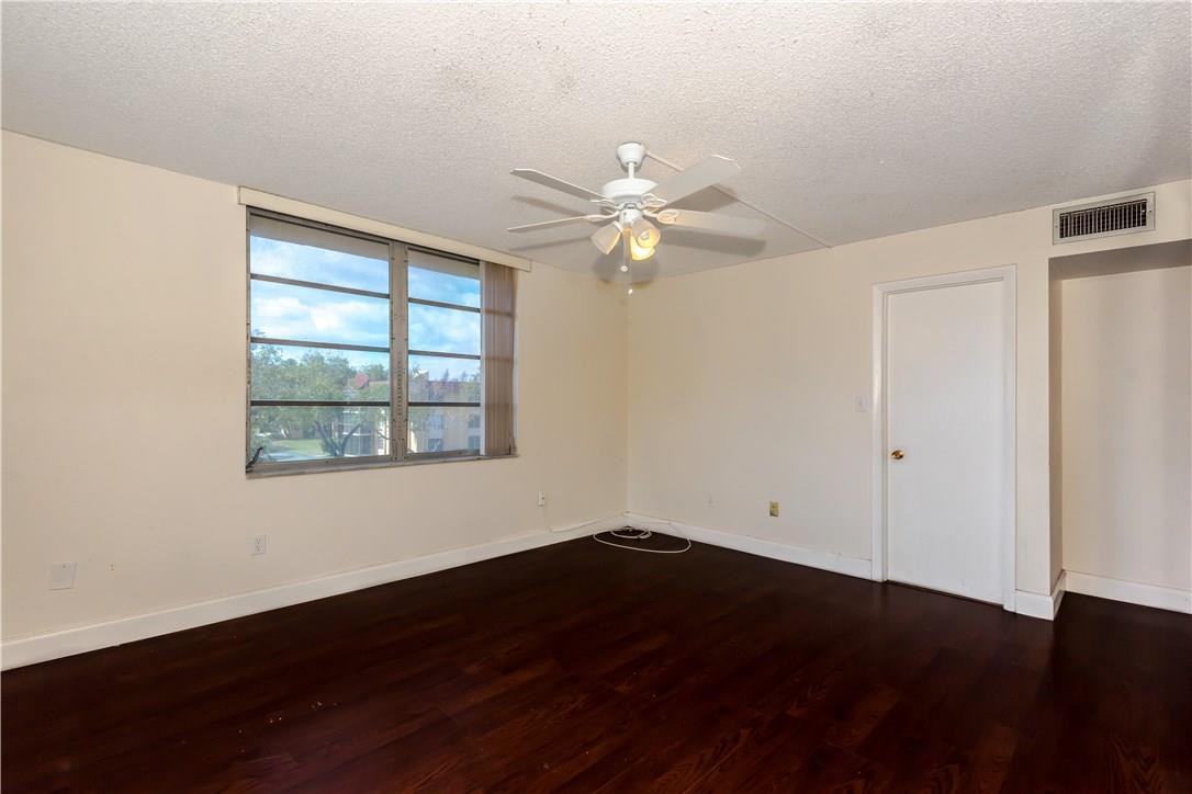 3285 Foxcroft Road, Unit E317 Miramar, FL 33025 - Photo 14 of 28 wooden floor in an empty room with a window