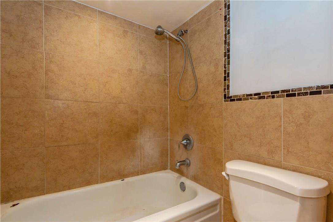 3285 Foxcroft Road, Unit E317 Miramar, FL 33025 - Photo 18 of 28 a bathroom with a toilet a sink and a shower
