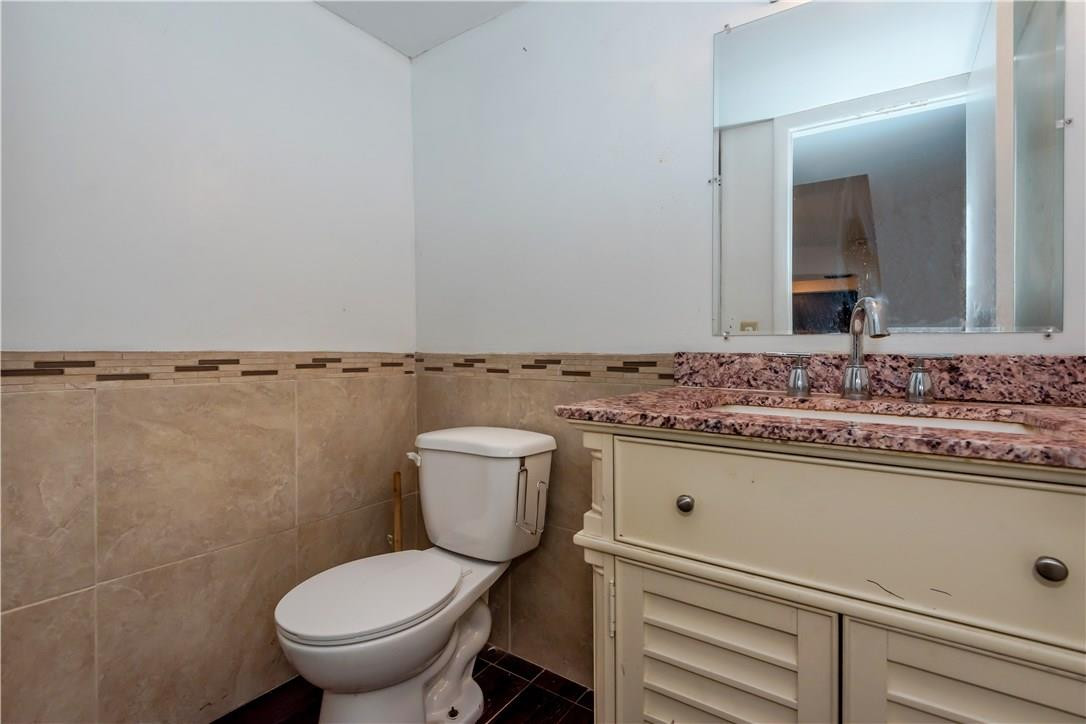 3285 Foxcroft Road, Unit E317 Miramar, FL 33025 - Photo 24 of 28 a bathroom with a sink and a toilet