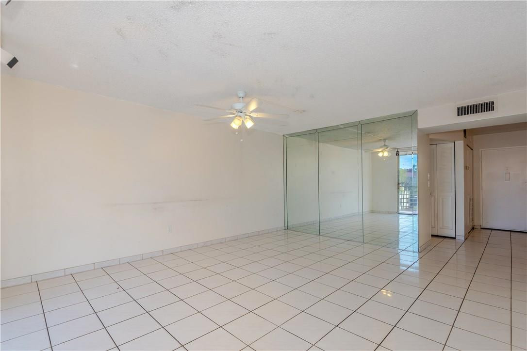 3285 Foxcroft Road, Unit E317 Miramar, FL 33025 - Photo 3 of 28 an empty room with kitchen view