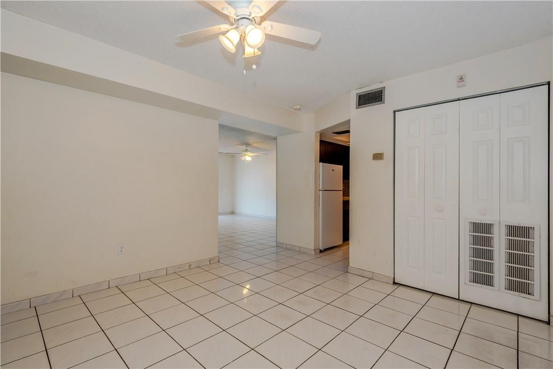 3285 Foxcroft Road, Unit E317 Miramar, FL 33025 - Photo 8 of 28 a view of an empty room and chandelier fan