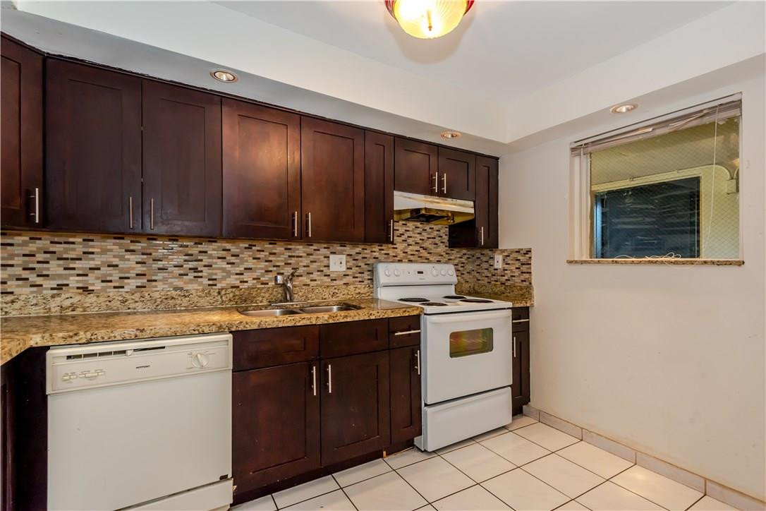 3285 Foxcroft Road, Unit E317 Miramar, FL 33025 - Photo 9 of 28 a kitchen with a stove cabinets and microwave