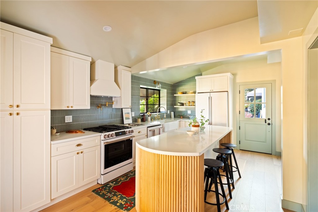 1578 Morada Place Altadena, CA 91001 - Photo 14 of 58 a kitchen with stainless steel appliances granite countertop a stove top oven a sink a dining table and chairs