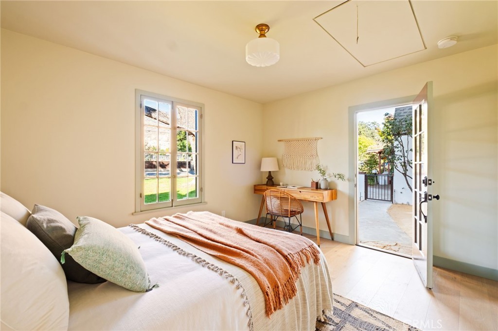 1578 Morada Place Altadena, CA 91001 - Photo 38 of 58 a bedroom with a large bed and a chandelier