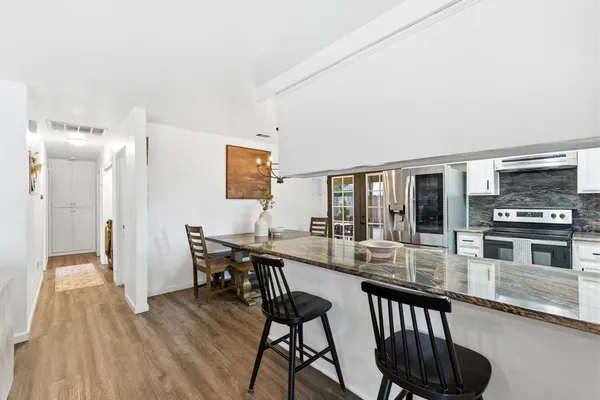 a view of a dining room with furniture window and wooden floor