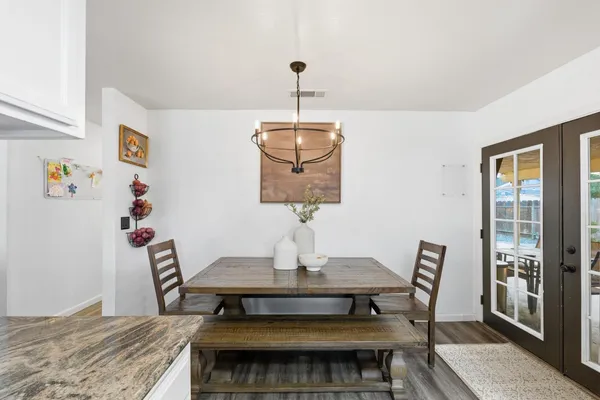 a dining room with a table and chairs