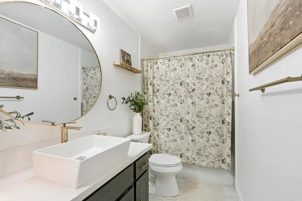 a bathroom with a sink toilet and shower