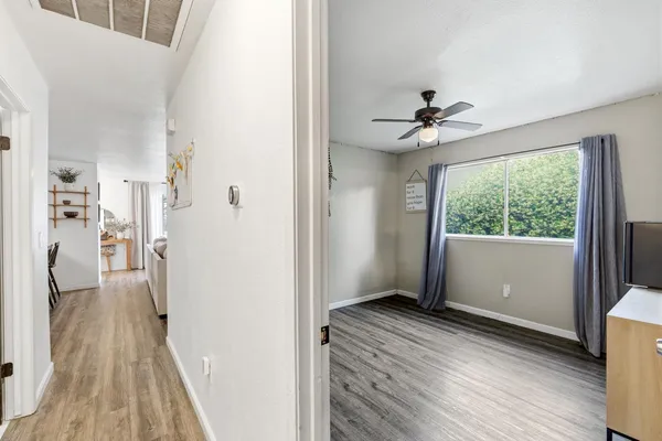 a view of livingroom with hardwood floor and a ceiling fan