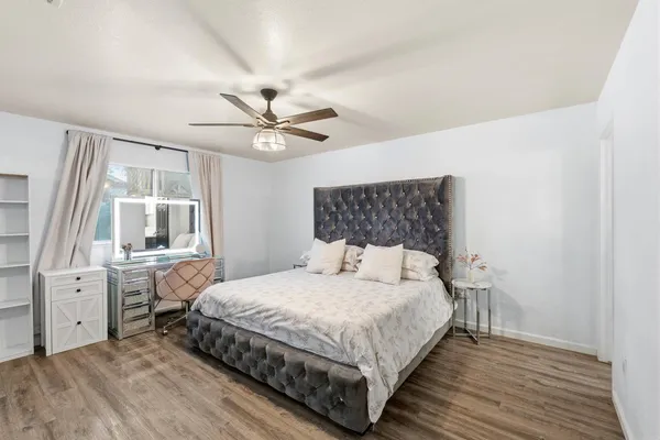 a bedroom with a large bed and a chandelier