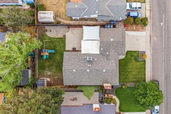 an aerial view of a house with a yard