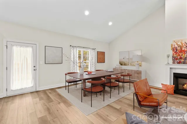 a living room with furniture a fireplace and a table