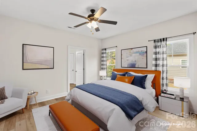 a bedroom with a bed and wooden floor