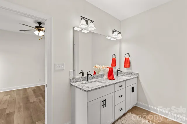 a bathroom with sinks and a chandelier