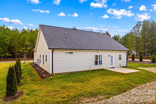 a view of a house with backyard and tree s