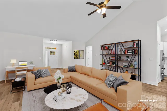 a living room with furniture and a wooden floor