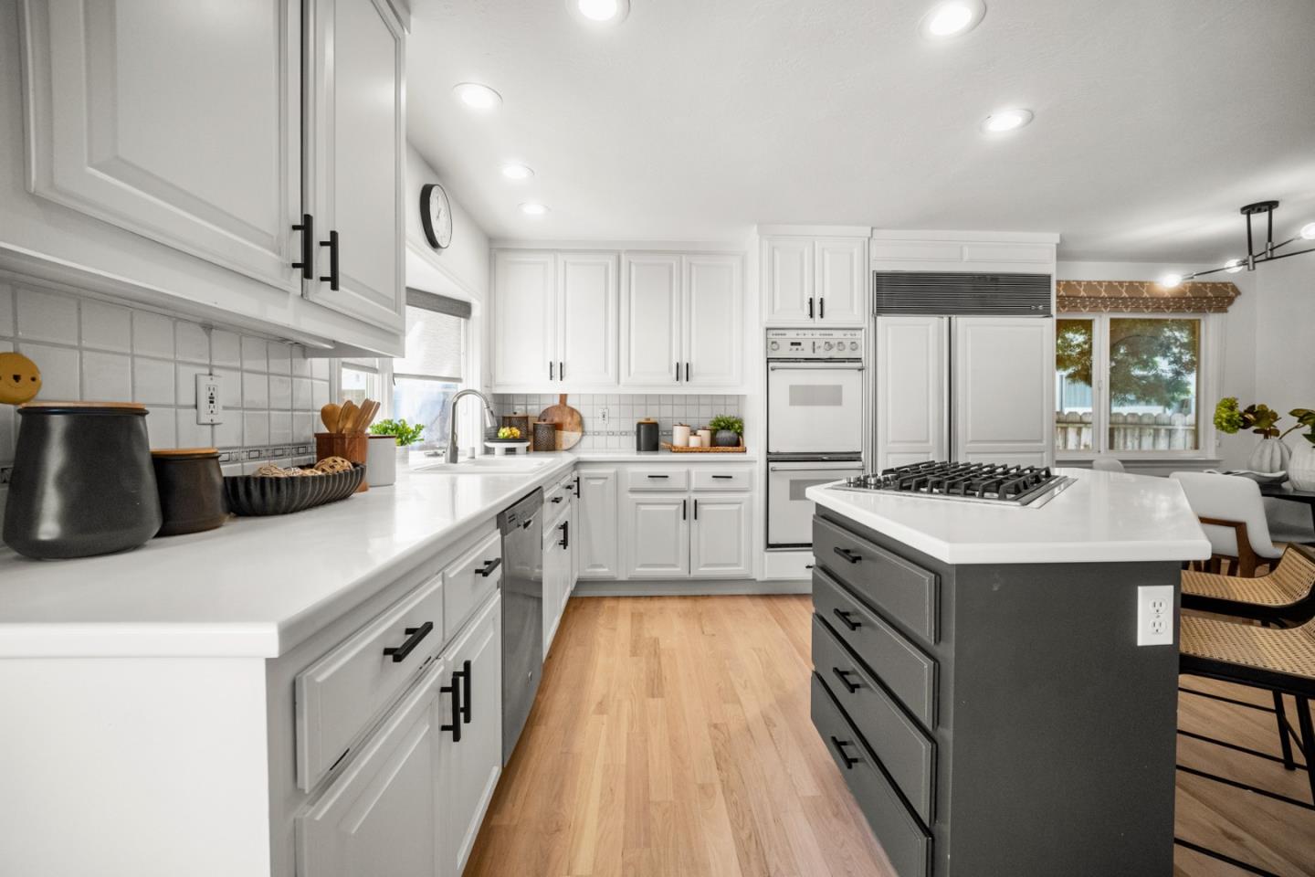 861 Haddock Street Foster City, CA 94404 - Photo 15 of 40 a kitchen with kitchen island a sink a stove a refrigerator and white cabinets