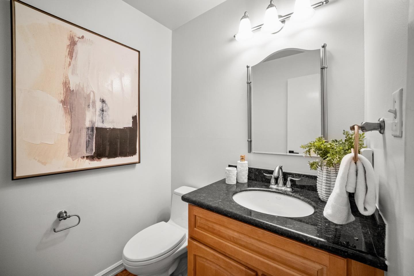 861 Haddock Street Foster City, CA 94404 - Photo 20 of 40 a bathroom with a granite countertop sink vanity mirror and toilet