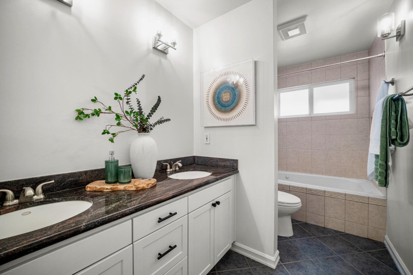 861 Haddock Street Foster City, CA 94404 - Photo 32 of 40 a bathroom with a granite countertop sink a toilet and a mirror