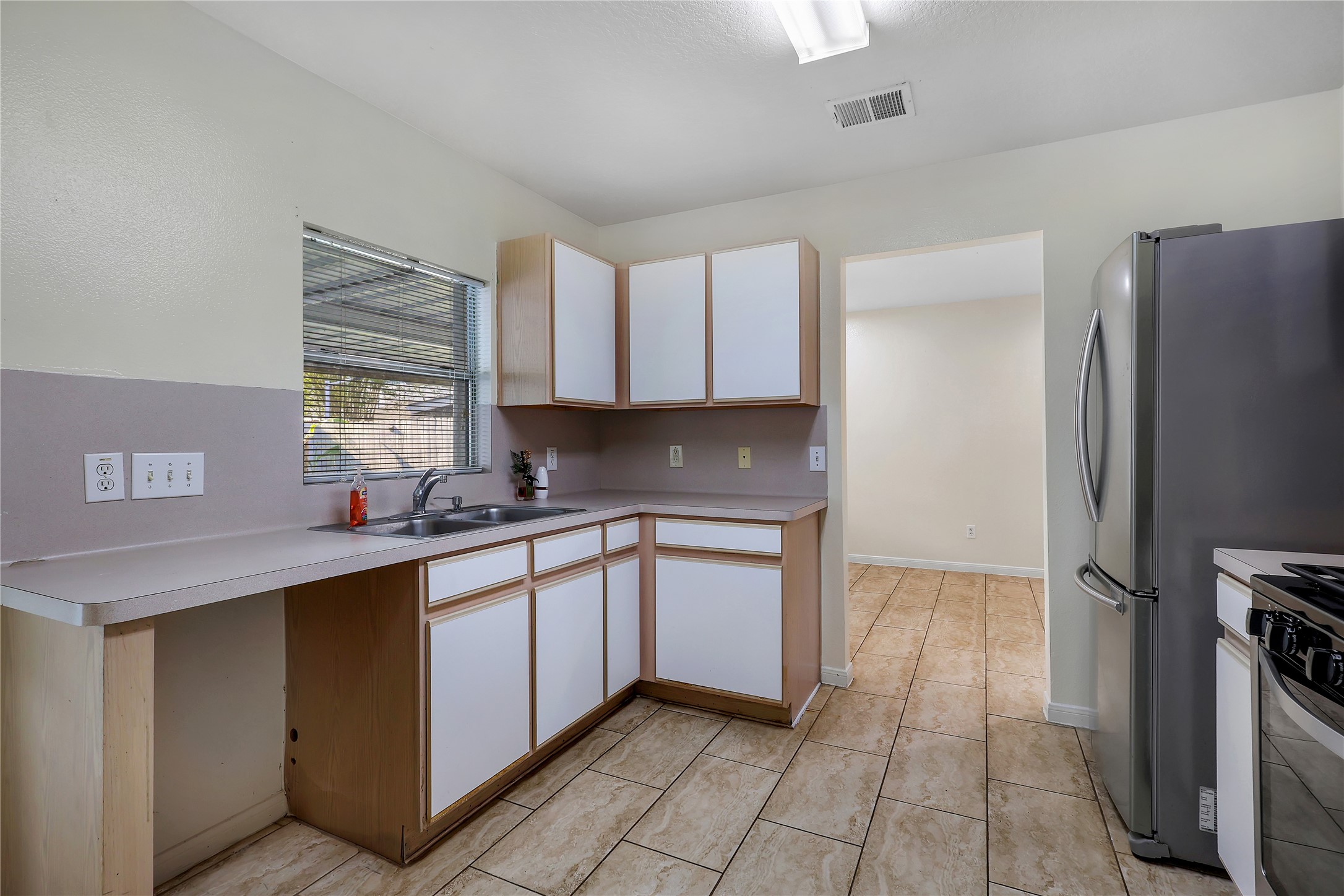 1117 Willersley Lane Channelview, TX 77530 - Photo 20 of 27 a kitchen with stainless steel appliances granite countertop a sink stove and refrigerator