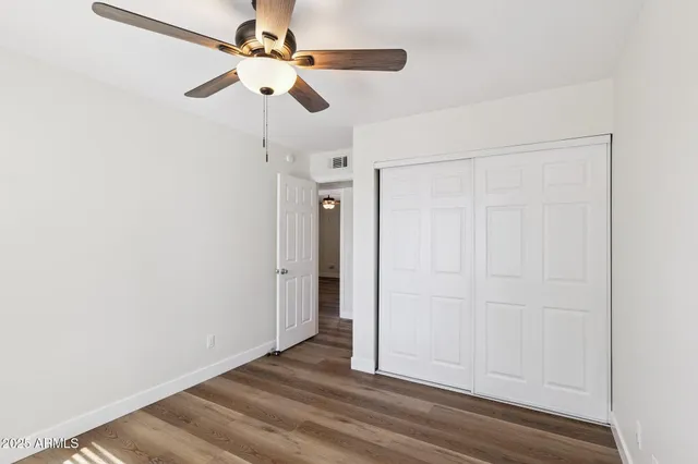 a bathroom with a granite countertop sink mirror and toilet