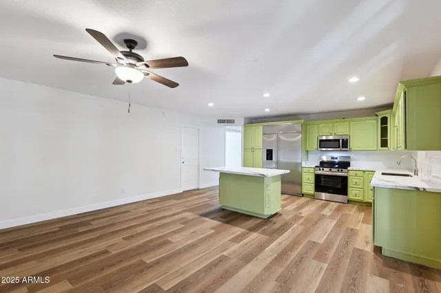 a view of a kitchen with wooden floor and a kitchen