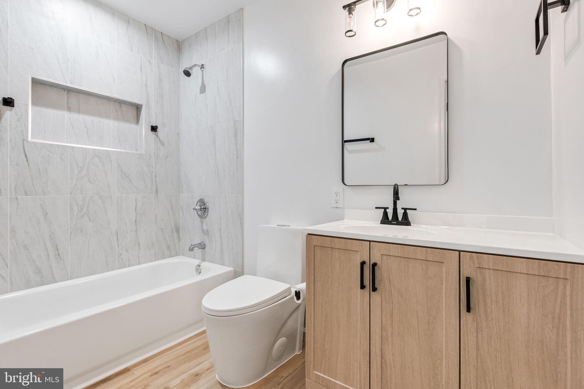 3 Boston Cove Ruther Glen, VA 22546 - Photo 20 of 30 a bathroom with a toilet a sink a mirror a bathtub and vanity