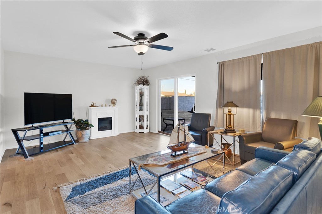 12887 Sholic Road Apple Valley, CA 92308 - Photo 15 of 47 a living room with furniture and a flat screen tv