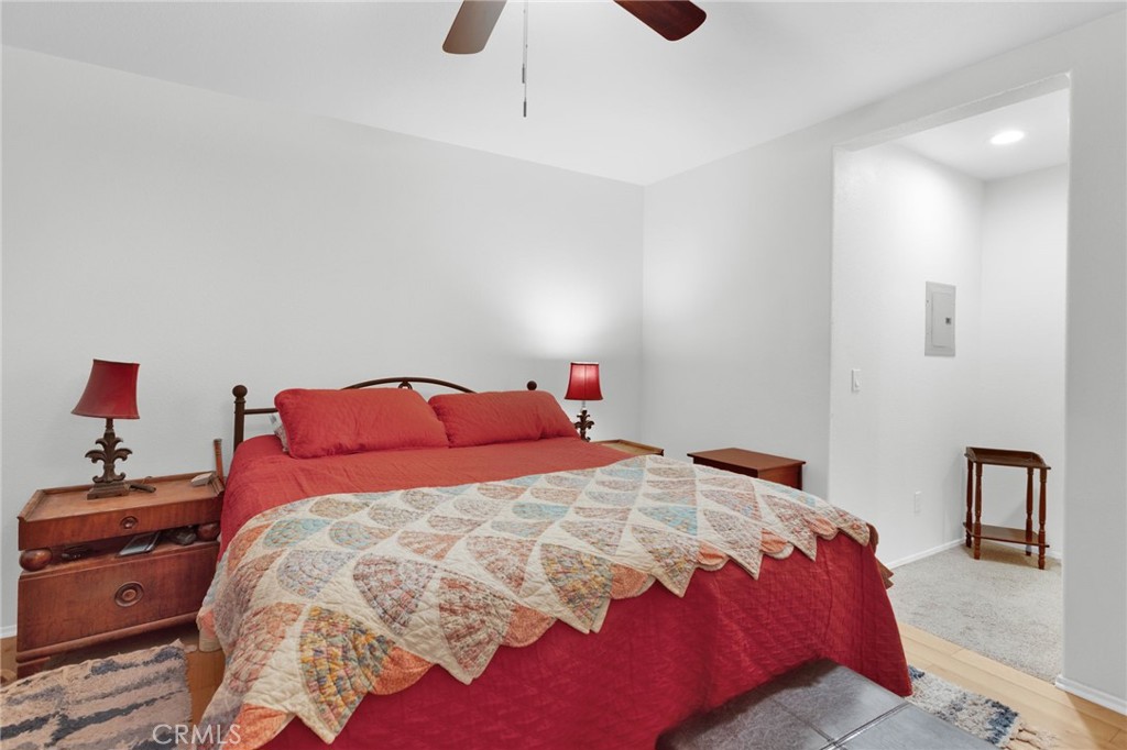 12887 Sholic Road Apple Valley, CA 92308 - Photo 17 of 47 a bedroom with a bed and a lamp