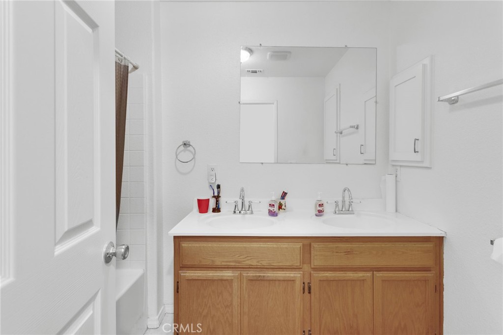 12887 Sholic Road Apple Valley, CA 92308 - Photo 18 of 47 a bathroom with a sink and a mirror