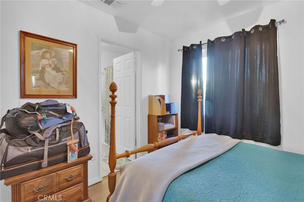 12887 Sholic Road Apple Valley, CA 92308 - Photo 20 of 47 a bedroom with a bed and a dresser